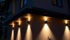 Modern Outdoor Wall Lighting Ideas: Modern outdoor wall lighting illuminating a contemporary home exterior at dusk